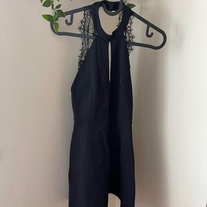 Black halter dress with lace detailing on the back
Size: S